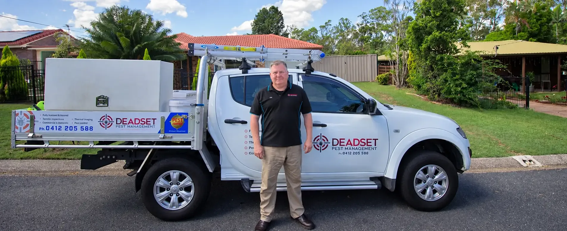 Jon Tatham, owner of Deadset Pest Management, beside his work ute