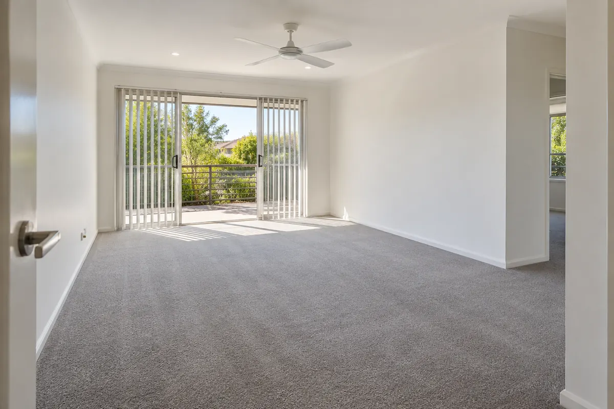 Empty rental living room with clean carpet ready for the final inspection